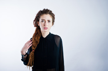 Studio shoot of girl in black with dreads on white background.