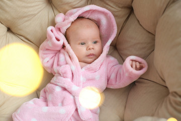Cute little baby lying on big soft pillow, top view