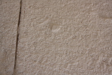 Pale plastered wall texture background in black and white with vignette