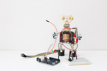 A metal robot and an electronic board that can be programmed. Robotics and electronics. A robot assembly builder. Laboratory in the school. Mathematics, engineering, science.