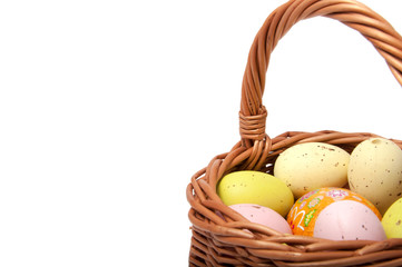 Easter eggs in the basket on white background