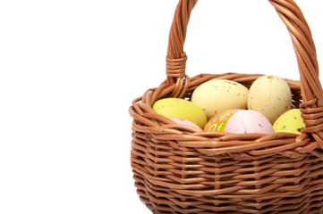 Easter eggs in the basket on white background