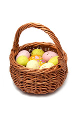Easter eggs in the basket on white background