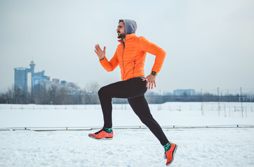 Focused athlete running on snow