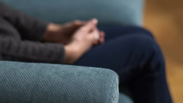 blurred woman's hands during session by the psychotherapist: anxiety, stress 