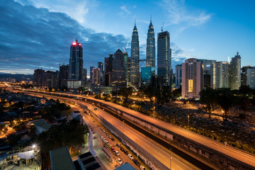Naklejka na ściany i meble Kuala Lumpur skyline and skyscraper with highway road at night in Kuala Lumpur, Malaysia. Asia.