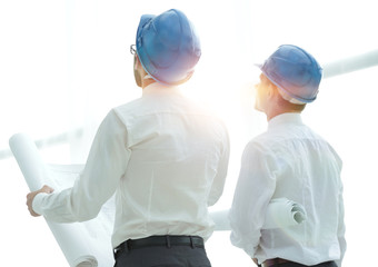 rear view.architect and Builder looking at blank screen