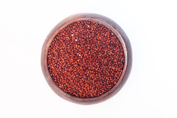 Obraz na płótnie Canvas Red quinoa grains in wooden bowl on white background.