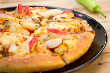 Pizza be appetizing on wooden background.
