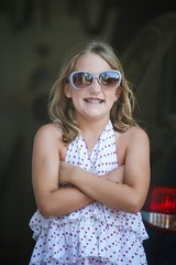 Obraz premium Sill Girl in Garage with Sunglasses Making Faces