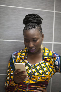 Braided woman checking her phone