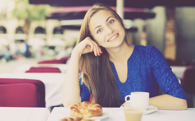 Young woman is dreaming in time breakfast