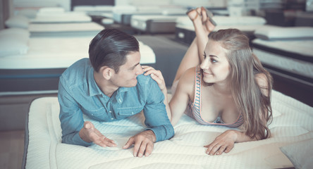 Nice couple choosing mattresses