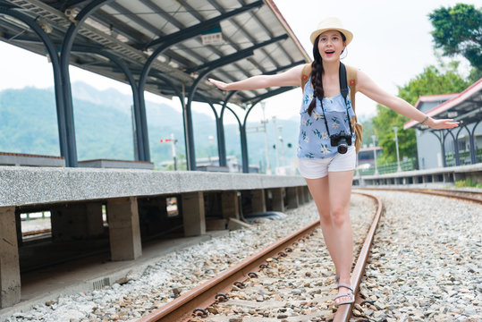 girl walking on railway track balance
