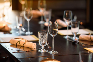 A glass of wine is placed on the dinner table.