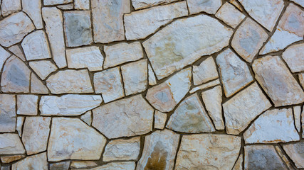 Grunge stone wall with irregular pattern- background or texture