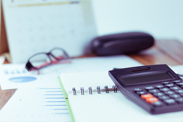 A black calculator placed on a business executive's desk, an elite development concept of a company.