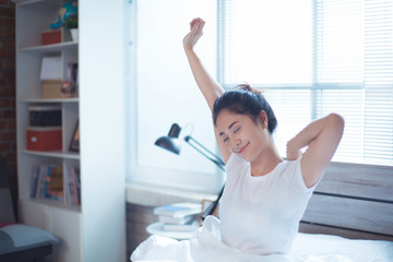 Asian women She is in bed and was waking up in the morning. She felt very refreshed.