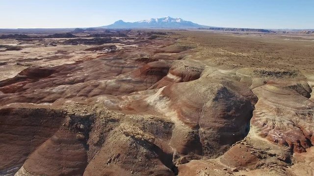 Aerial view flying backwards over the Mars desert in Utah near the MDRS in Hanksville Utah.