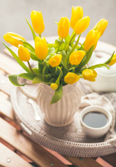 Yellow tulips and fresh tea