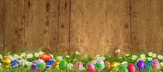 Ostern - Wiese mit Ostereiern und Holzhintergrund