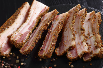 smoked speck cut in slices, close-up