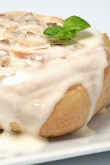Tasty roll with cinnamon, apples, mint leaf and whiped cream - closeup photo.