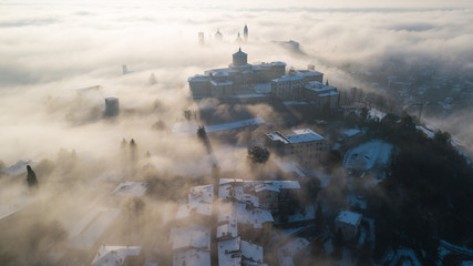 Bergamo, Italy. Drone aerial view of an amazing landscape of the fog rises from the plains and covers the old town