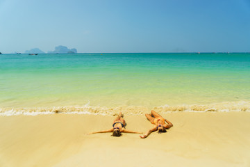 Fototapeta na wymiar Two women resting at the tropical Thailand beach