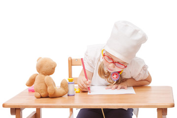 young girl with glasses plays in the doctor