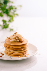 Banana cashew pancakes with bananas and caramel sauce.
