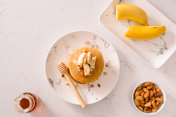 Banana cashew pancakes with bananas and caramel sauce.