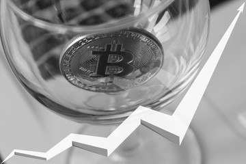 bitcoin on laptop background arrow is reflected in the glass