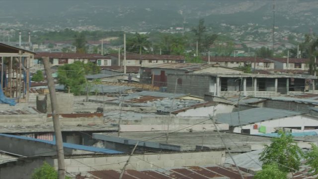 Panning Shot of Shantytown, Cit&eacute; Soleil, Port-au-Prince, Mountain in Background