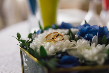 rings for the wedding ceremony lie on flowers