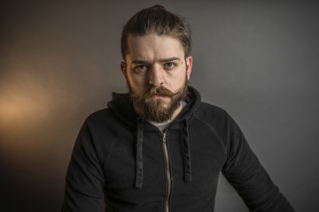Obraz premium Portrait of a bearded man in a black sweatshirt
