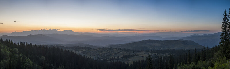 Sunset panorama landscape of mountains with forests