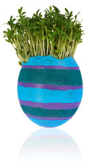 Handmade painted easter egg in a funny  cress like hair colored in blue, purple, light blue stripes.