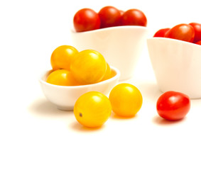 Small tomatoes red and yellow isolated on white background
