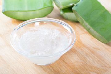 Fresh aloe vera leaves with aloe vera juice in glass bowl 
