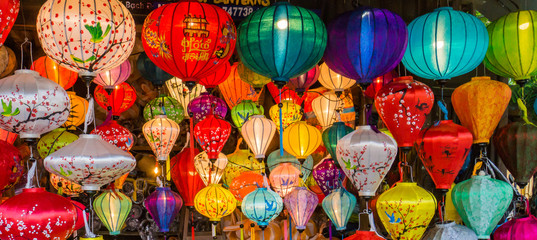 many colors of silk lanterns lit up at night © vermontalm