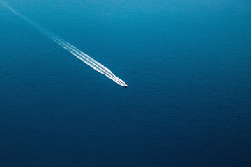 Aerial view of small boat flowing in Mediterranean sea, travel and vacation concept