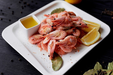 Boiled shrimp with pepper and Lavrushka. With the lemon slices and sauce