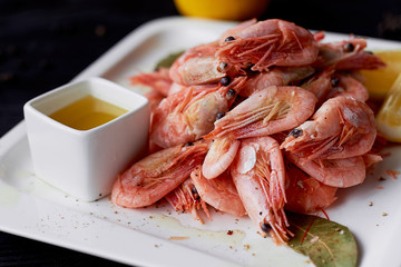 Boiled shrimp with pepper and Lavrushka. With the lemon slices and sauce
