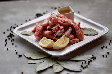 Boiled shrimp with pepper and Lavrushka. With the lemon slices and sauce