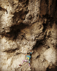 Rock-climbing in Turkey. The climber climbs on the route. Photo from the top.