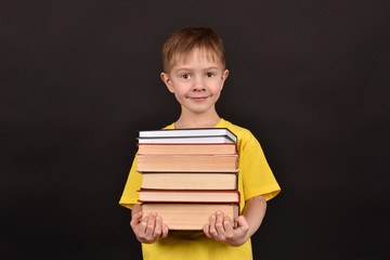 A schoolboy teaches lessons. A boy with books. A smart child. A read person.