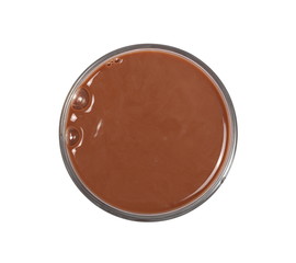 Chocolate milk in glass isolated on white background, top view