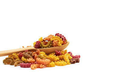 background of raw colored macaroni in the wooden spoon. Isolated on white background. copy space, template