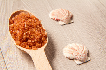 Spa nature products. Wooden spoon with brown sea salt for bathroom procedures